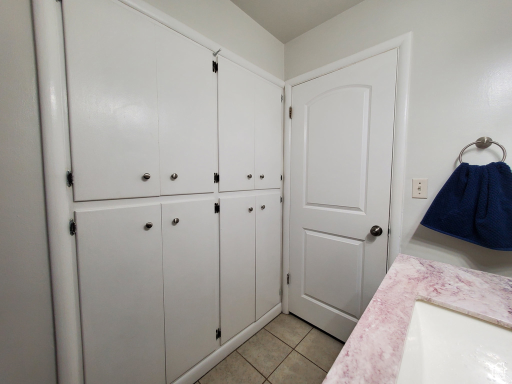 Bathroom with tile patterned floors and vanity