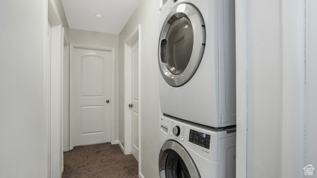 Washroom featuring estacked washer and dryer and carpet flooring