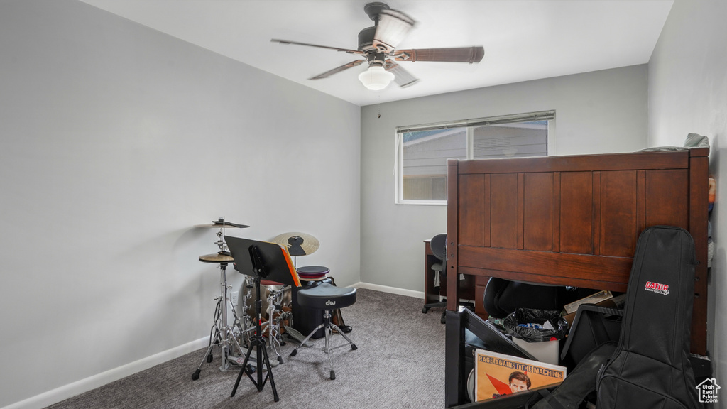 Office with carpet and a ceiling fan