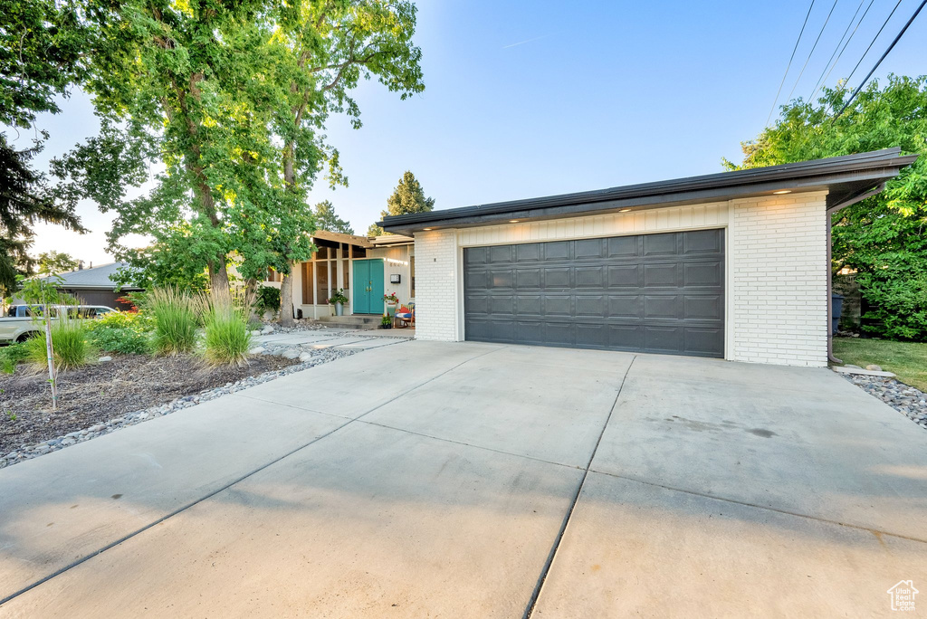 View of front of house with brick siding and driveway