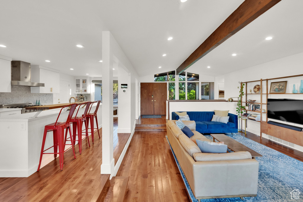 Living area with light wood-style floors and recessed lighting
