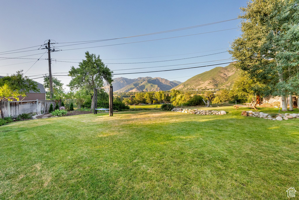 View of grassy yard with a mountain view