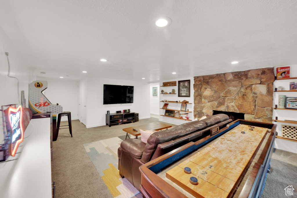 Living area featuring recessed lighting, carpet flooring, and a fireplace
