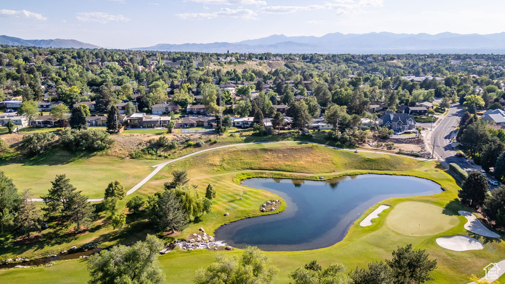 Aerial view of residential area featuring a water and mountain view and a golf course