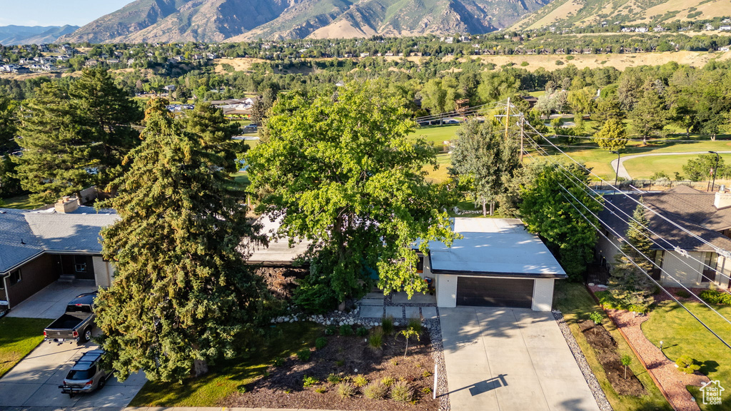Aerial view of property and surrounding area featuring a mountainous background