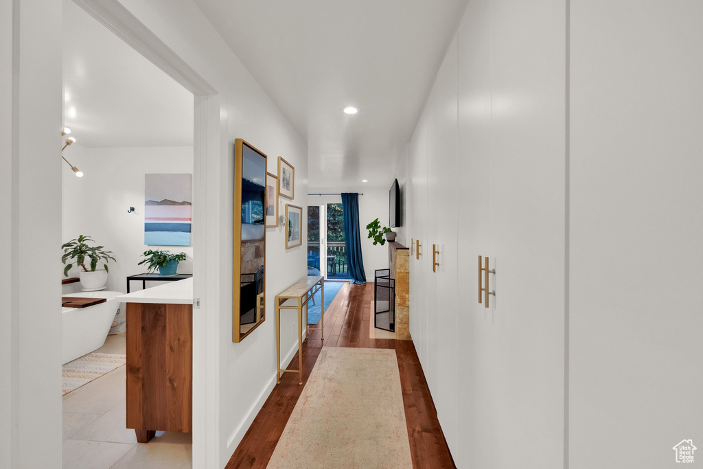 Corridor featuring recessed lighting and wood finished floors