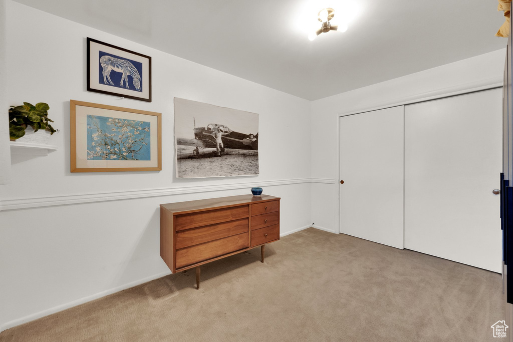 Carpeted bedroom featuring a closet and baseboards