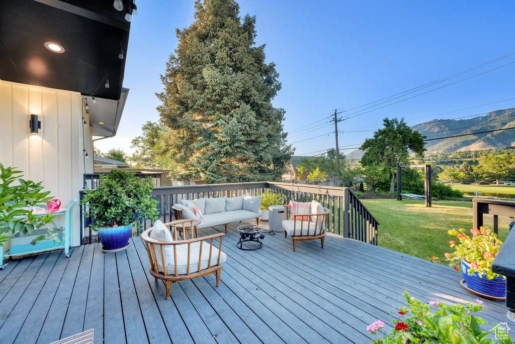 Deck featuring an outdoor hangout area and a yard