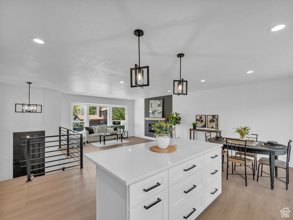 Kitchen featuring light wood-style floors, recessed lighting, light countertops, and white cabinets