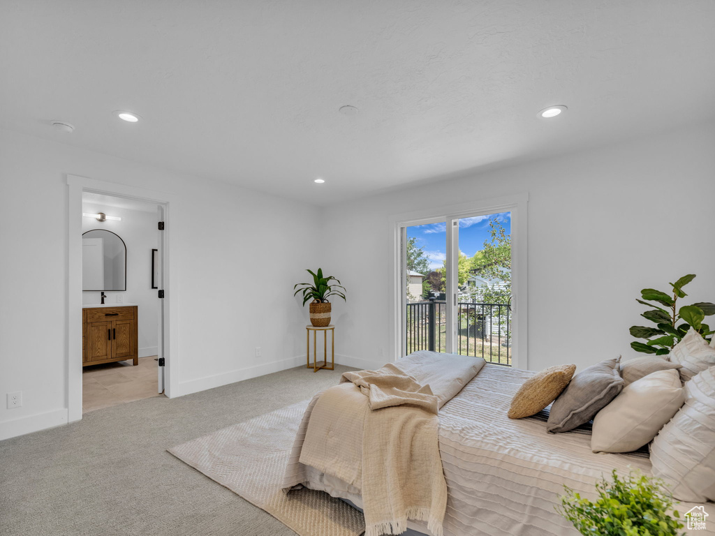 Bedroom featuring access to outside, recessed lighting, light carpet, and ensuite bath