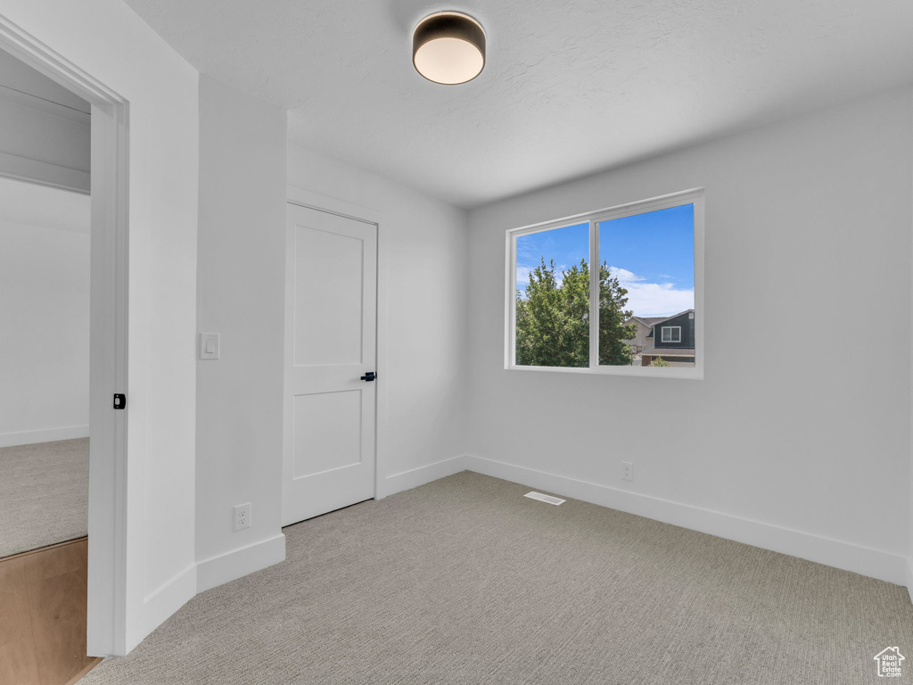 Unfurnished bedroom with carpet and baseboards