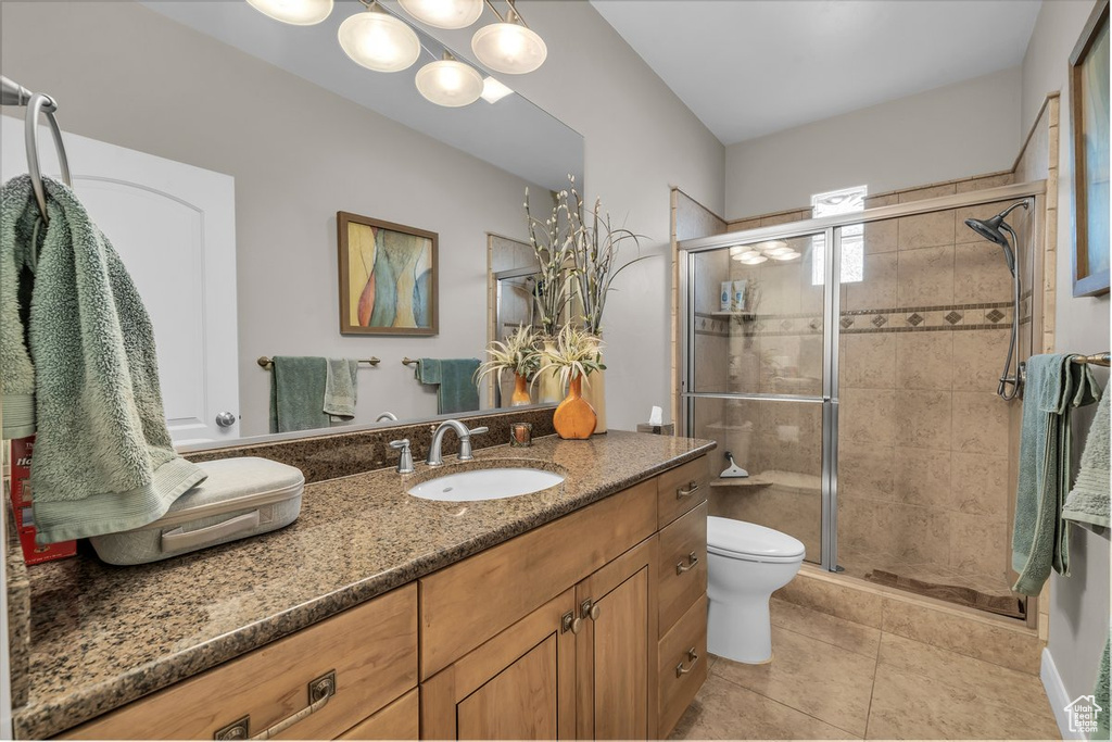 Full bathroom featuring vanity, tile patterned flooring, and a stall shower