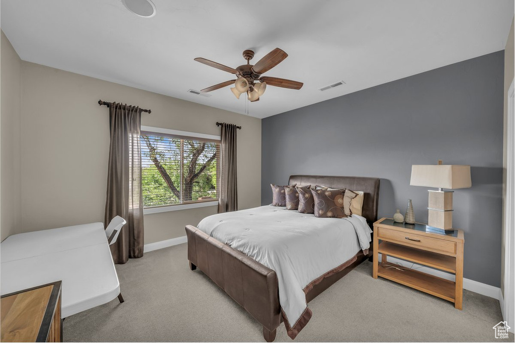 Bedroom featuring light carpet and ceiling fan