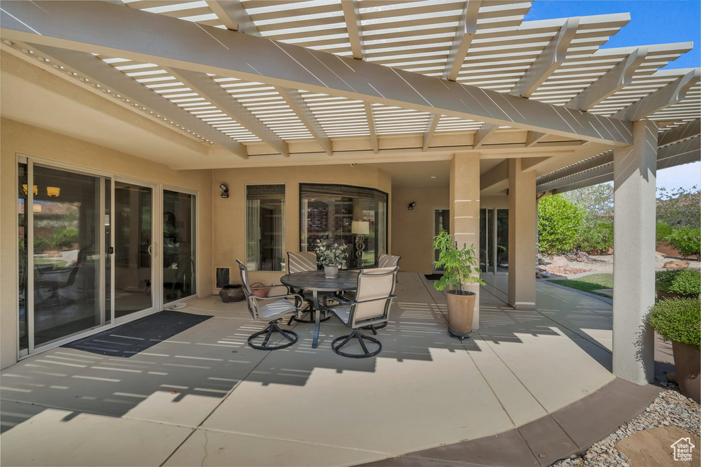 View of patio with a pergola and outdoor dining area