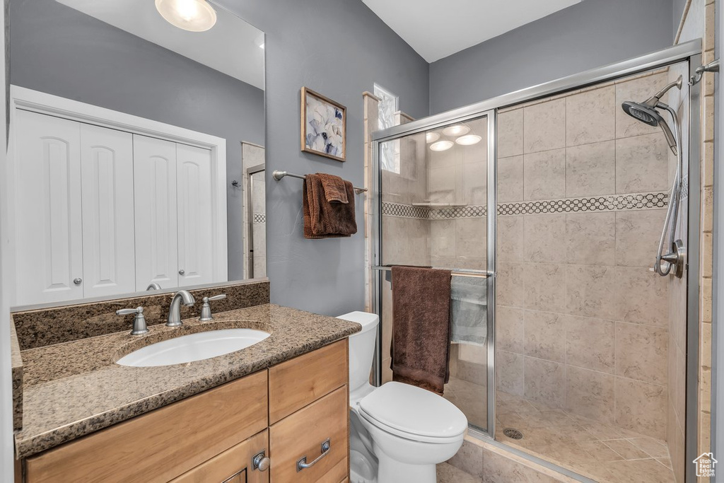 Bathroom with a shower stall and vanity