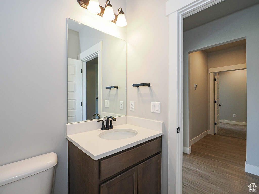 Bathroom with vanity and wood finished floors