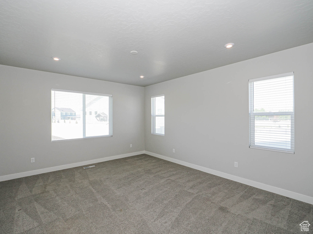 Unfurnished room featuring dark carpet and recessed lighting