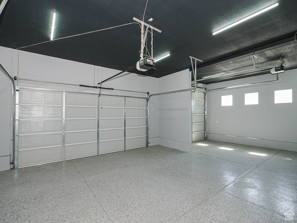 Garage featuring a garage door opener