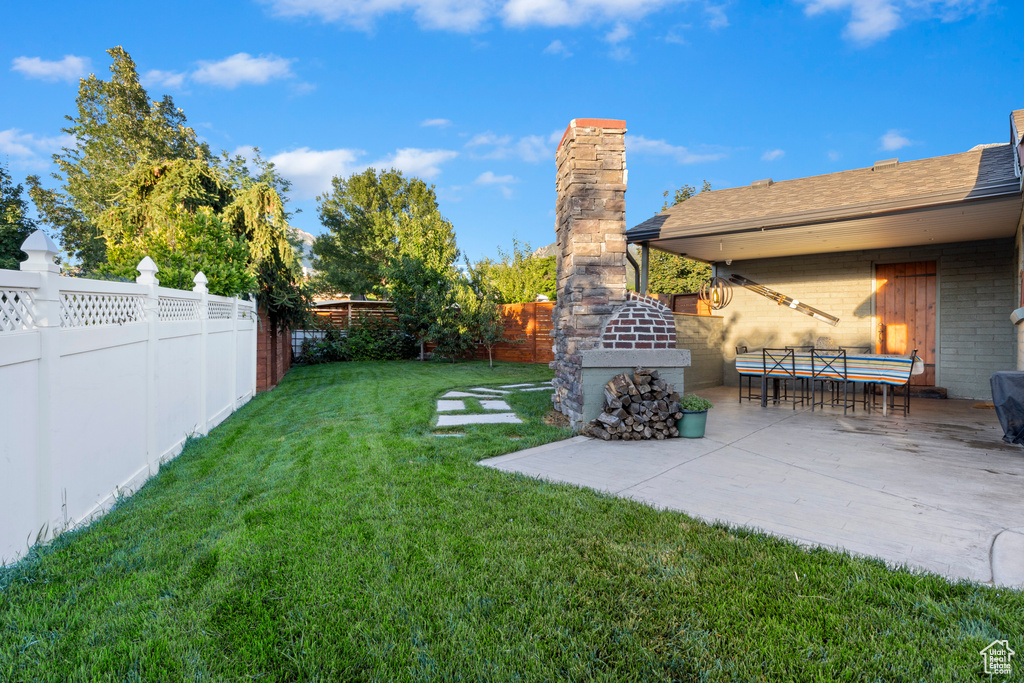 Fenced backyard featuring a patio