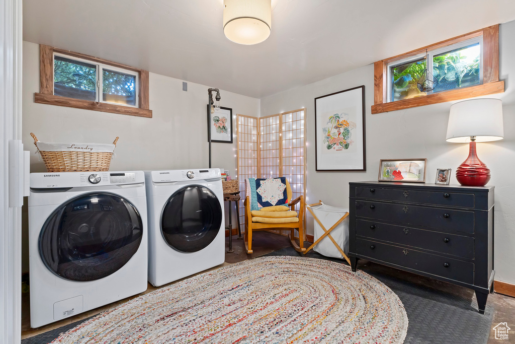 Laundry room with washing machine and clothes dryer and baseboards