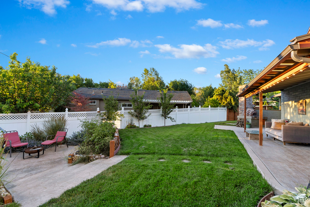 Fenced backyard with a patio and an outdoor hangout area