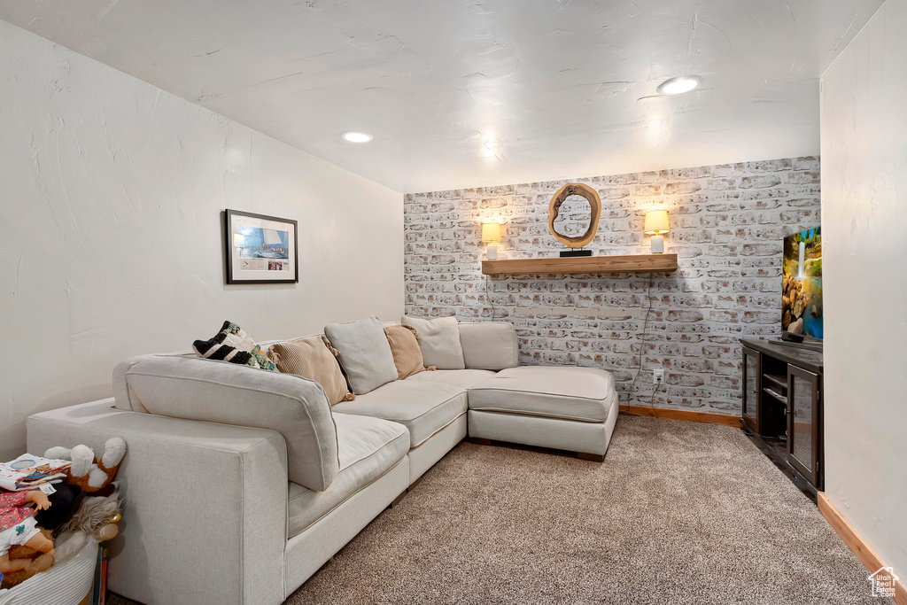 Carpeted living area featuring baseboards