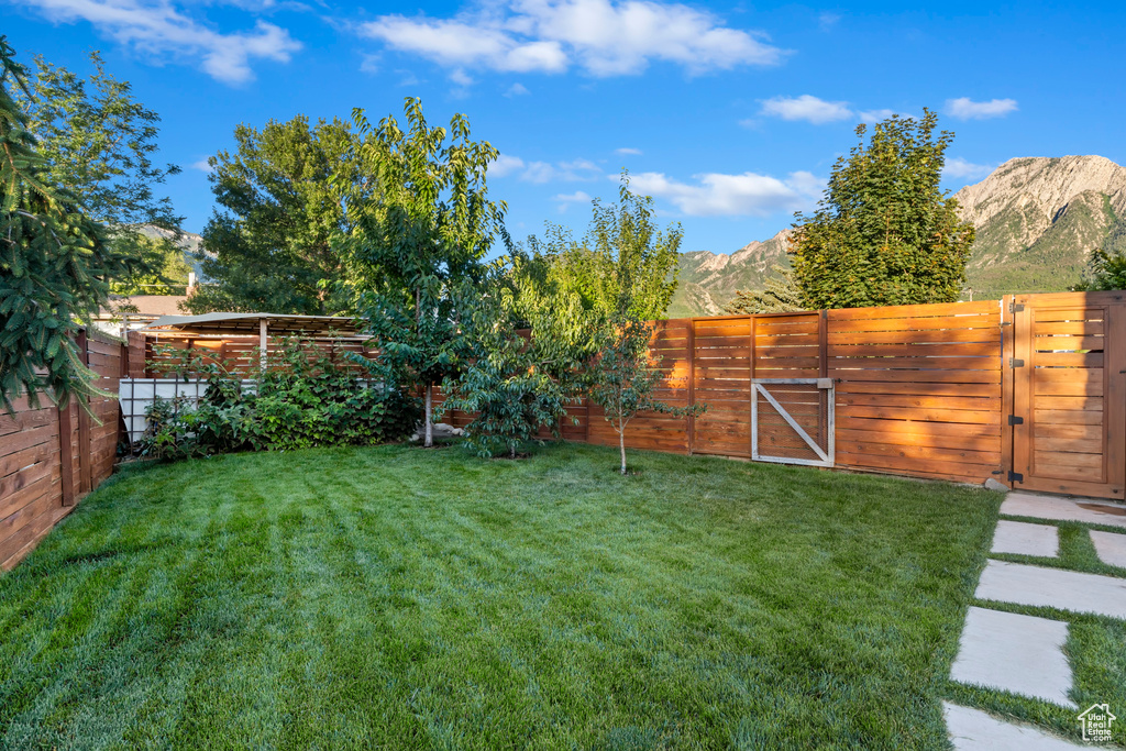 Fenced backyard with a gate and a mountain view