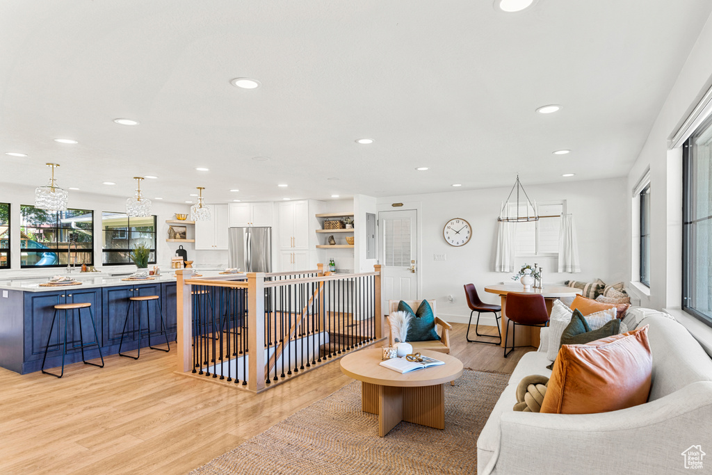 Living area featuring light wood-style flooring and recessed lighting