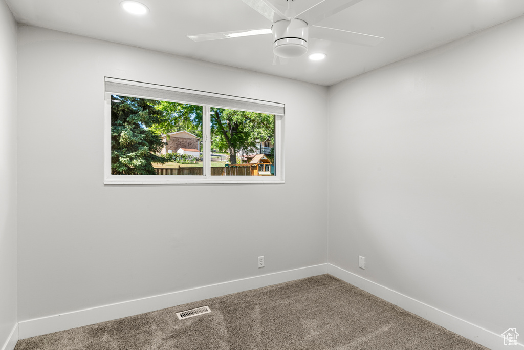 Empty room with carpet floors, recessed lighting, and ceiling fan