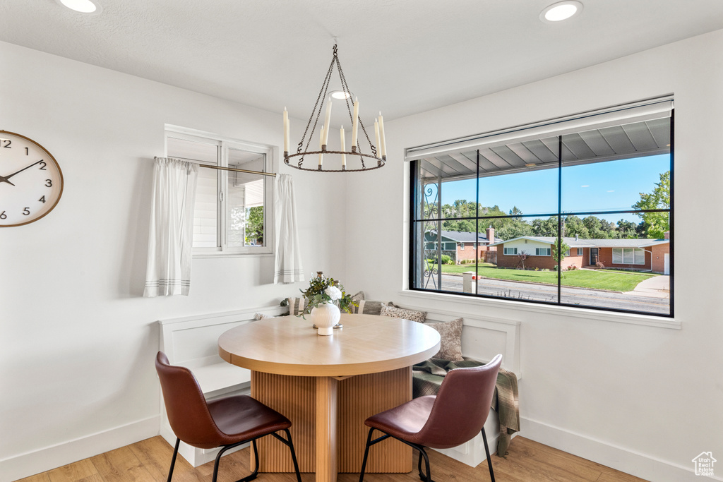 Dining area featuring a chandelier, light wood finished floors, and recessed lighting