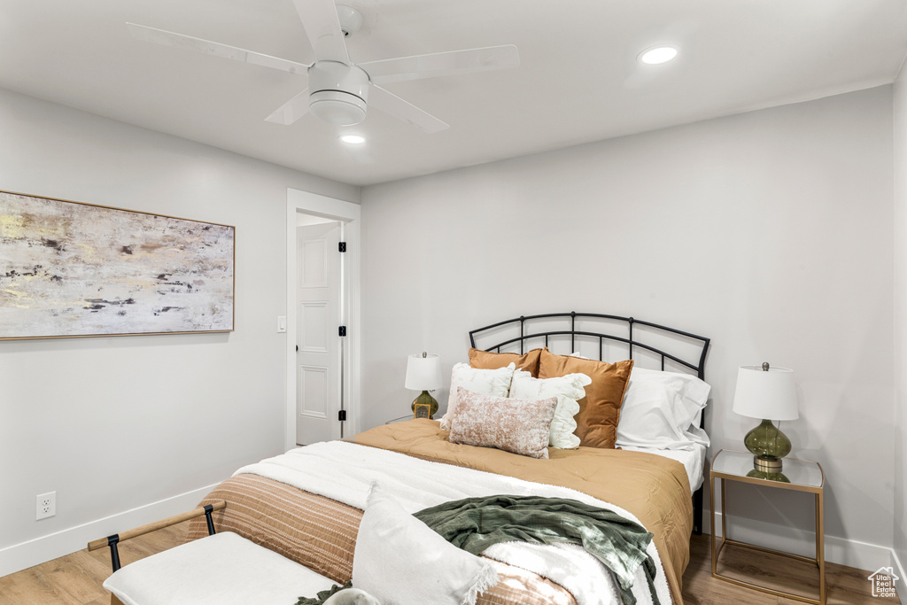Bedroom with wood finished floors, recessed lighting, and a ceiling fan