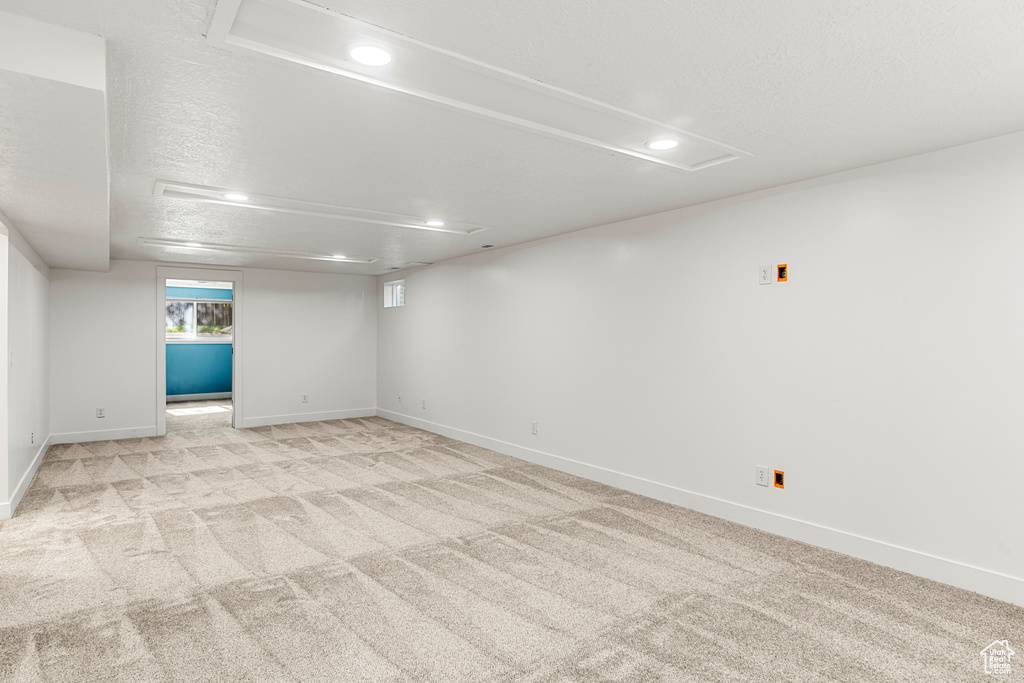 Basement featuring recessed lighting and light carpet