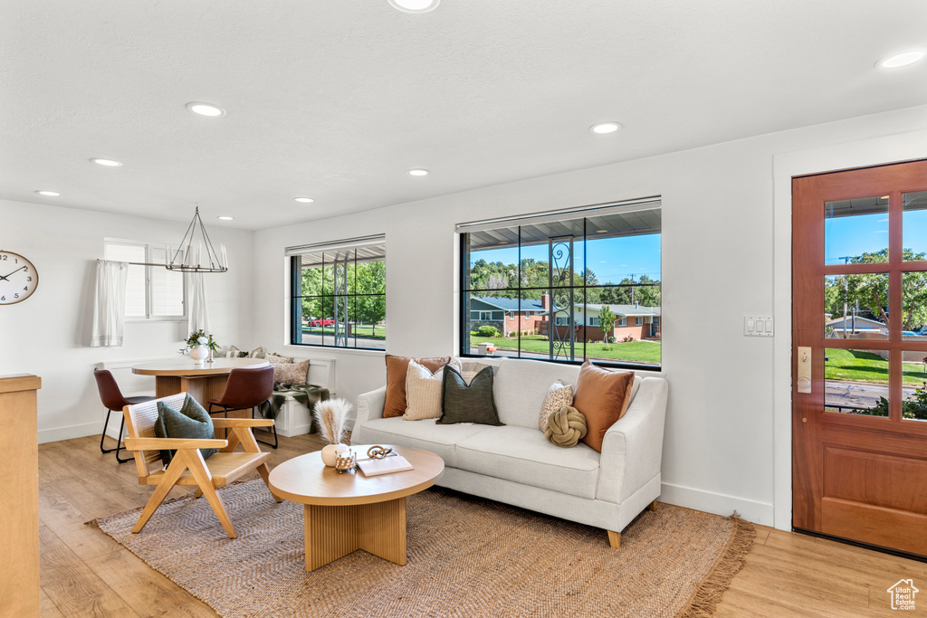 Living room with light wood finished floors and recessed lighting
