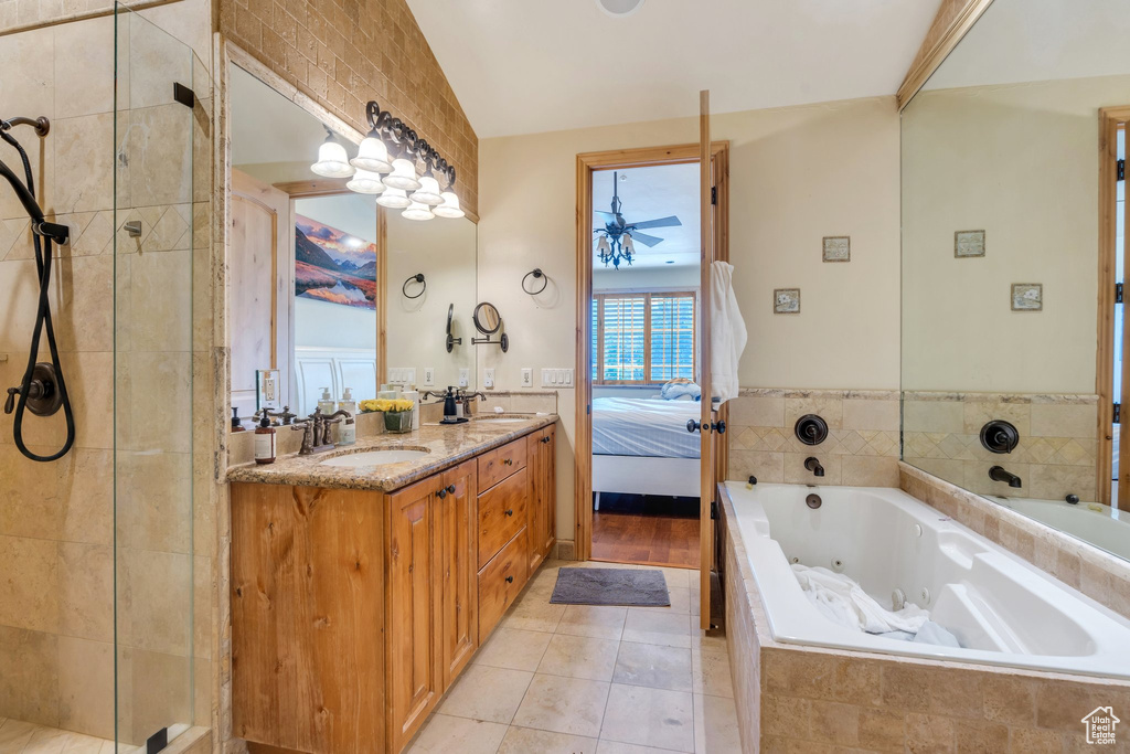 Bathroom featuring a whirlpool tub, double vanity, ensuite bathroom, a tile shower, and tile patterned floors