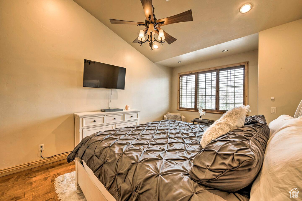 Bedroom with wood finished floors, recessed lighting, lofted ceiling, and a ceiling fan