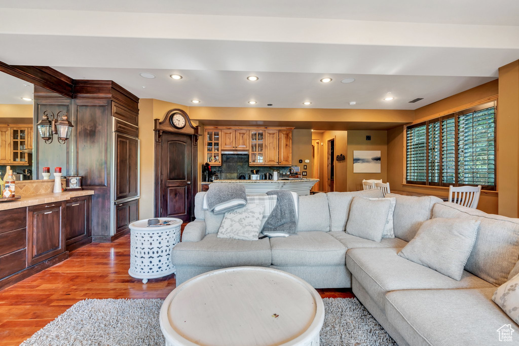 Living area with wood finished floors and recessed lighting