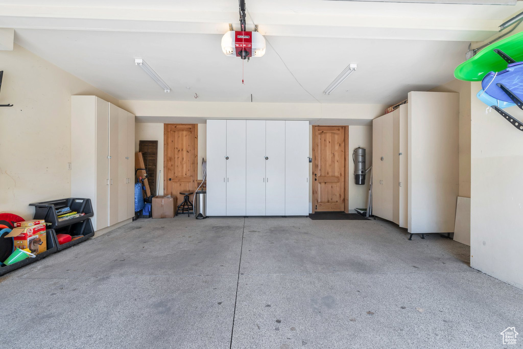 Garage with a garage door opener and a central vacuum unit