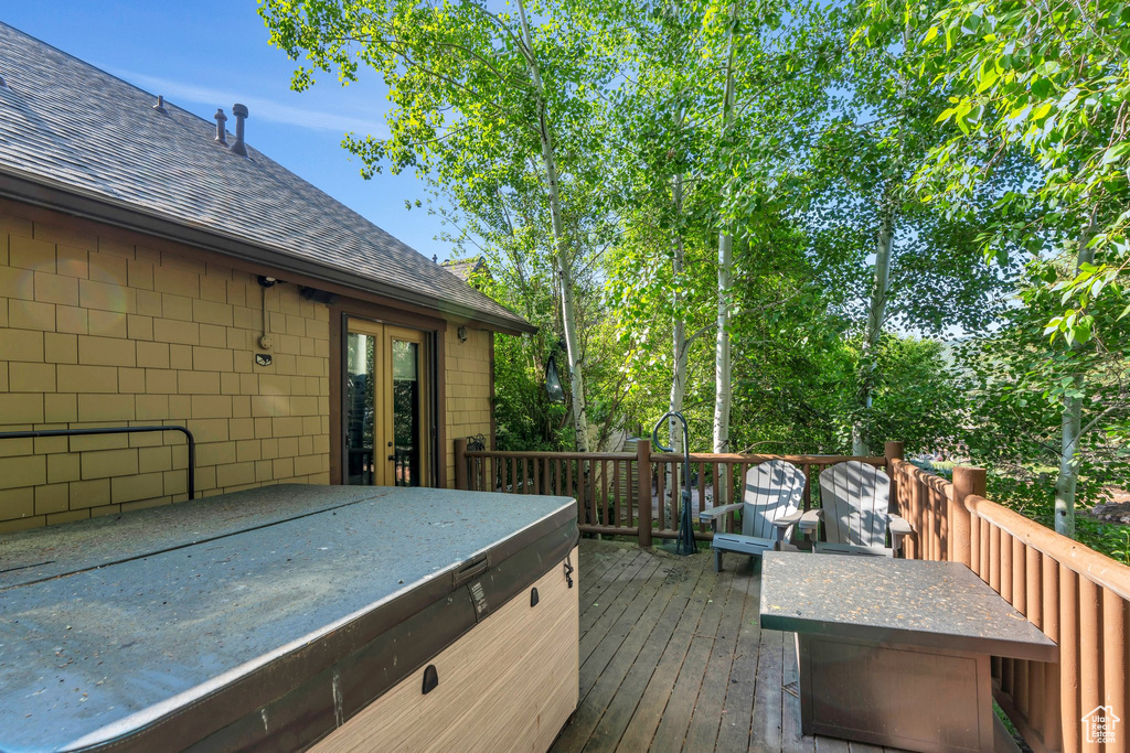 Deck featuring french doors and a hot tub