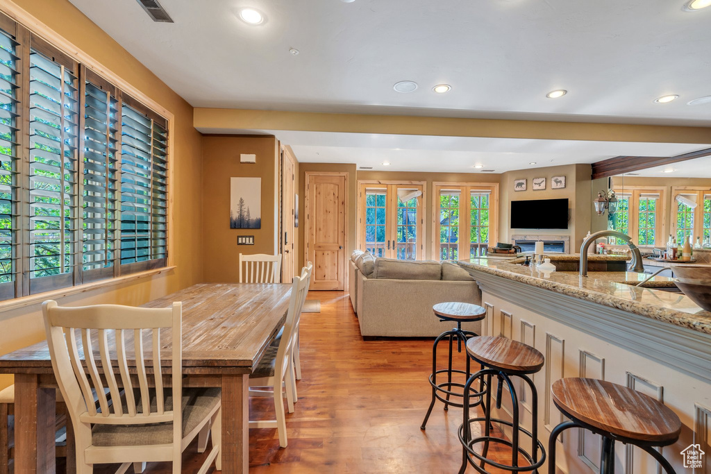 Dining space with light wood-style flooring and recessed lighting