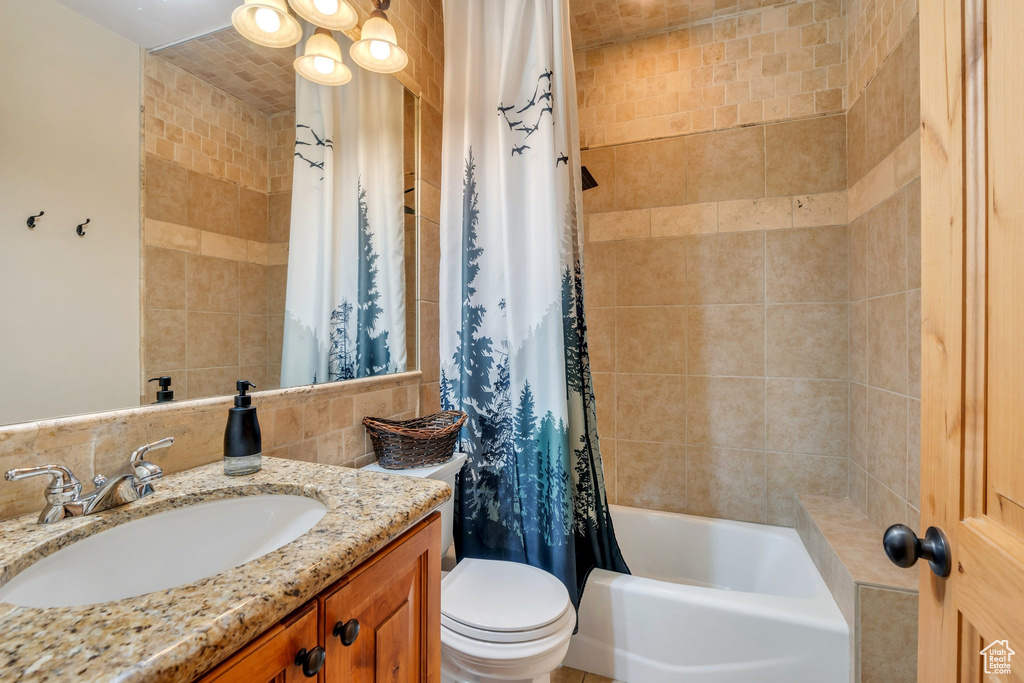 Full bathroom featuring vanity and shower / bath combo with shower curtain