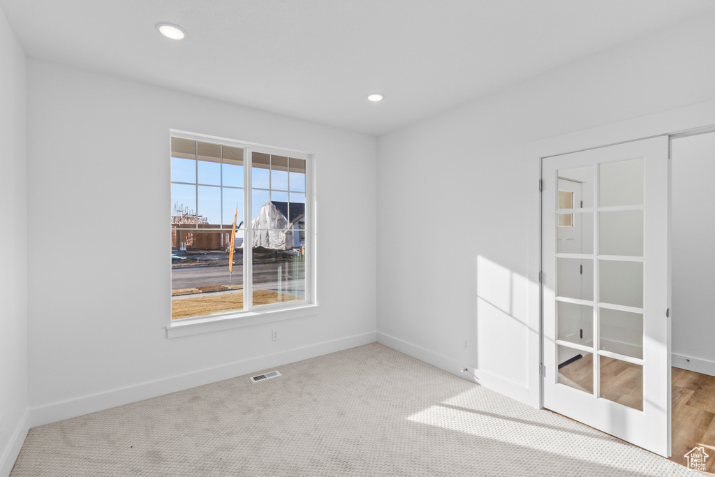 Unfurnished room with recessed lighting and carpet
