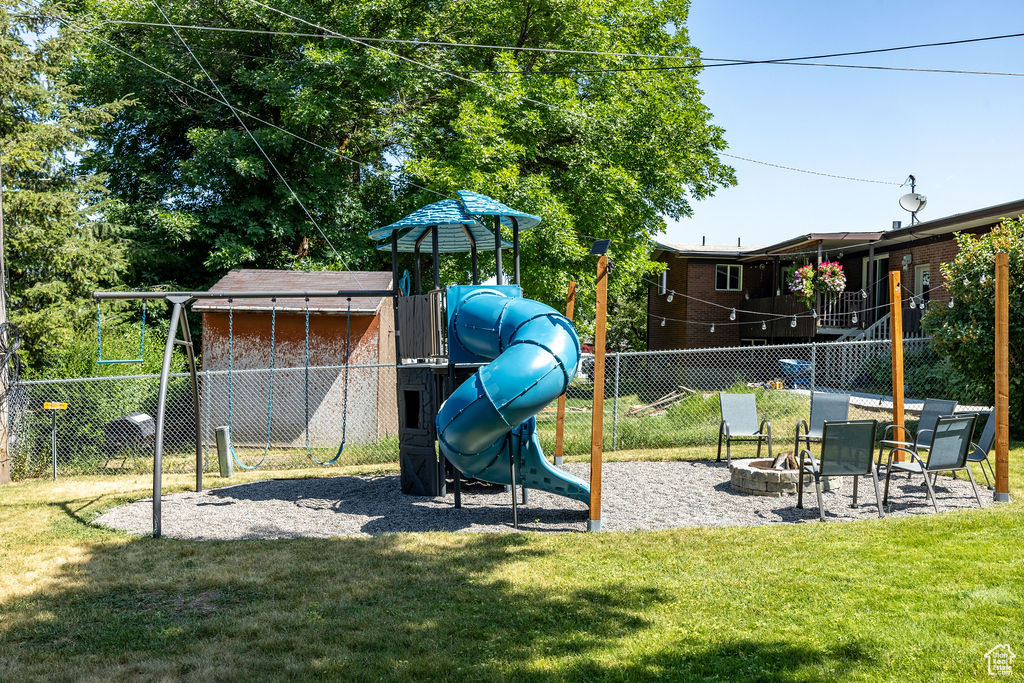 View of jungle gym featuring an outdoor fire pit