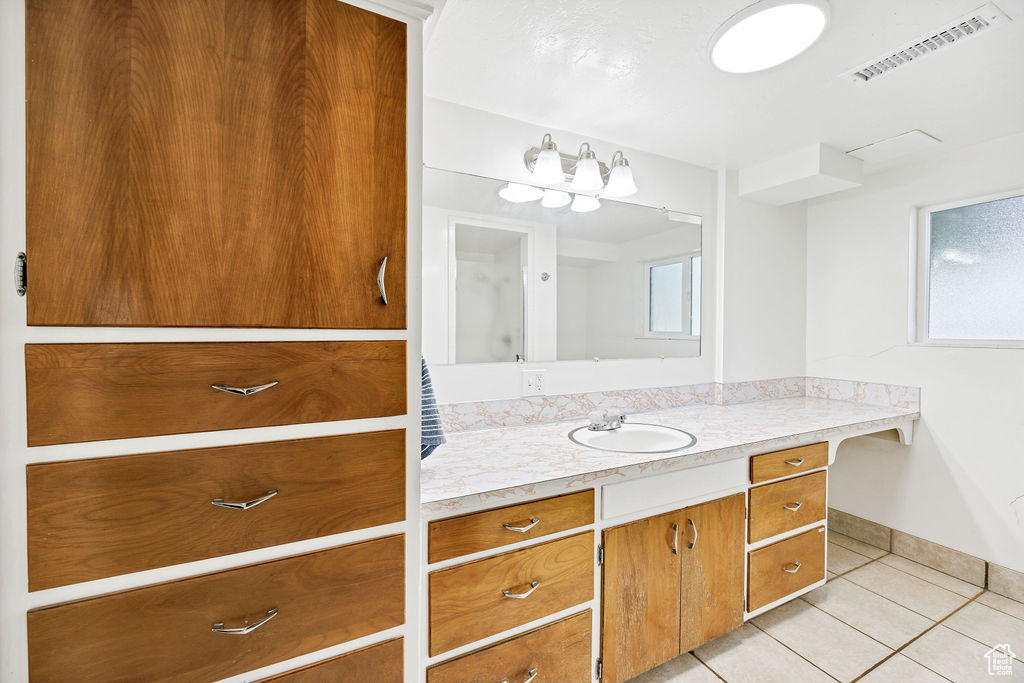 Bathroom with tile patterned floors and vanity