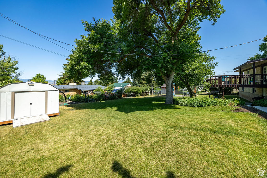 View of yard featuring a storage shed and stairway