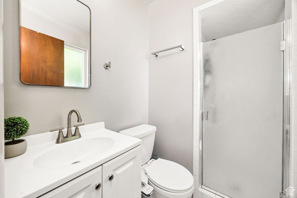 Full bathroom featuring a stall shower and vanity