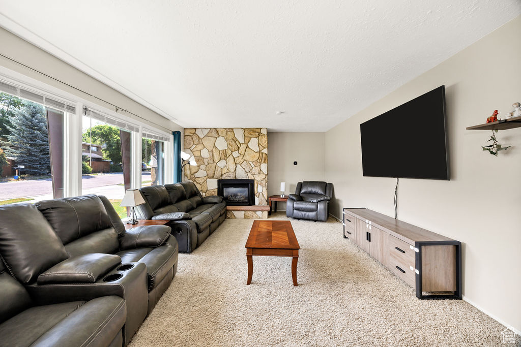 Living room with light colored carpet and a fireplace