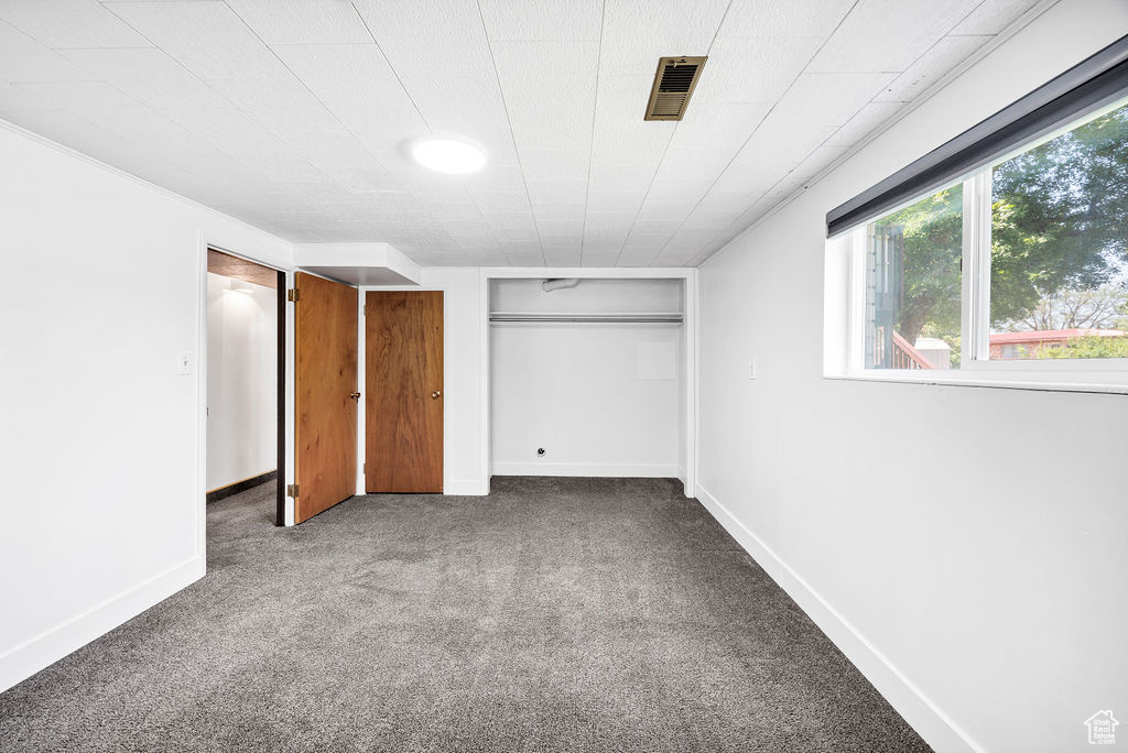 Unfurnished bedroom featuring carpet floors and baseboards
