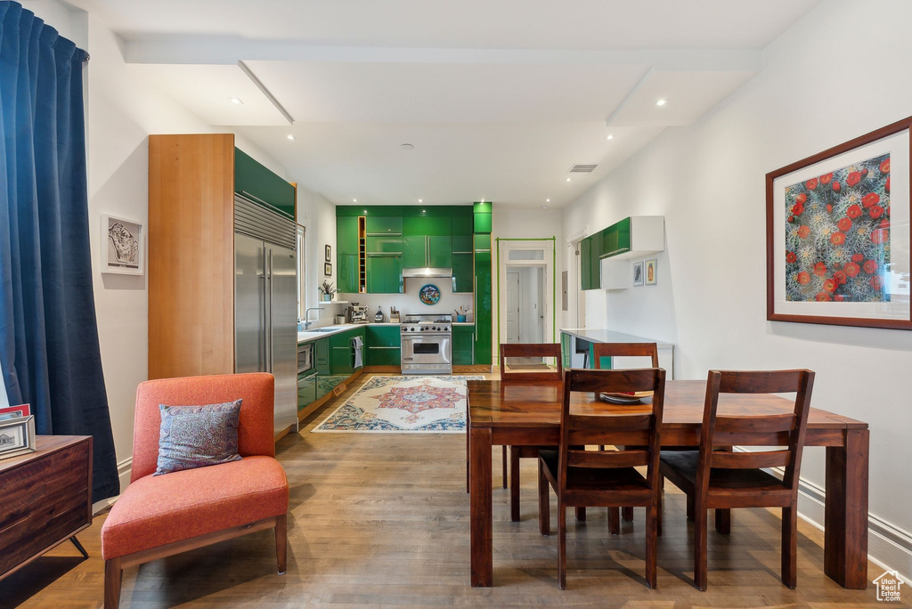 Dining room featuring light wood-style flooring and recessed lighting