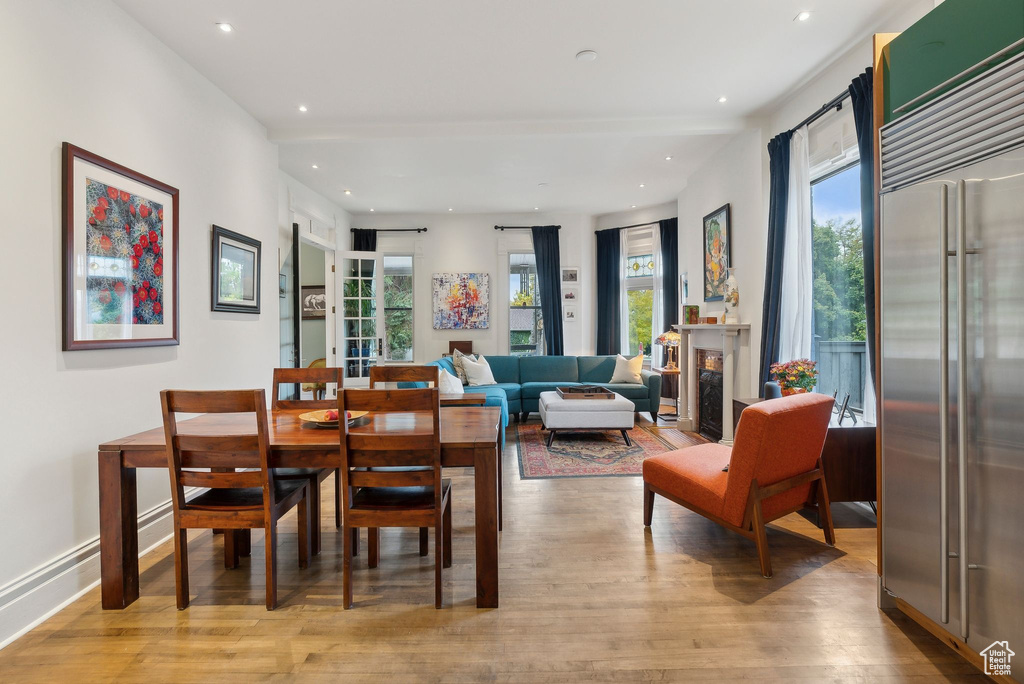 Dining space with wood finished floors and recessed lighting