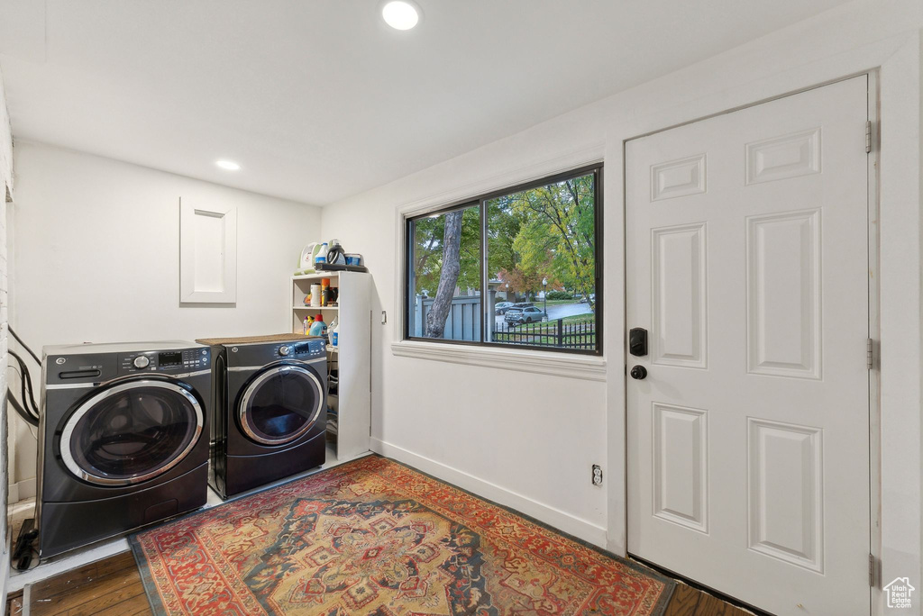 Laundry area with separate washer and dryer, recessed lighting, and wood finished floors